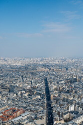 Aerial view of a sprawling city under blue sky.